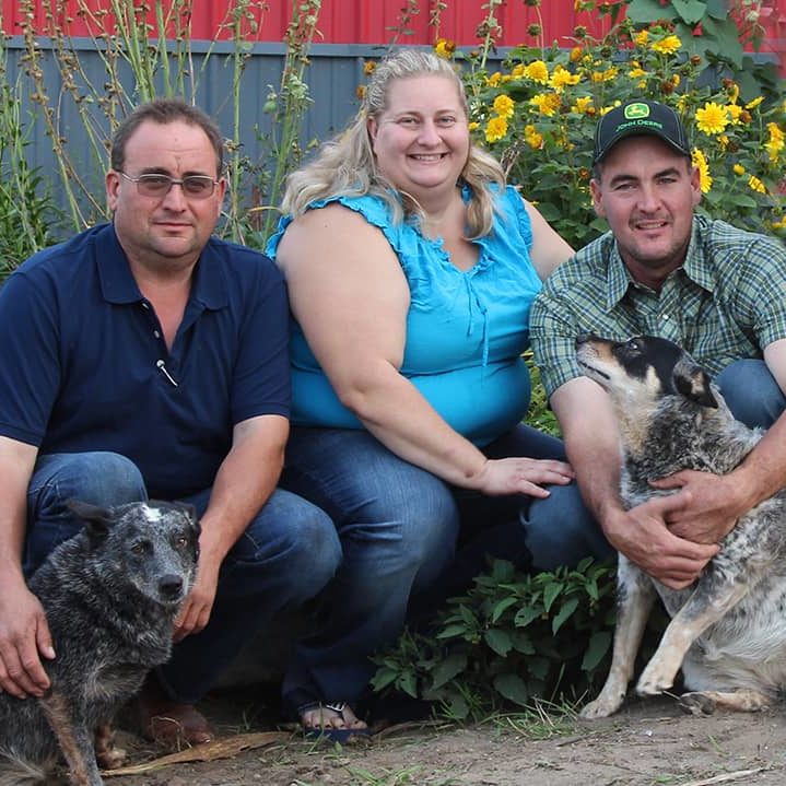 Megghan Honke Seidel poses with her husband, brother in law and two dogs.